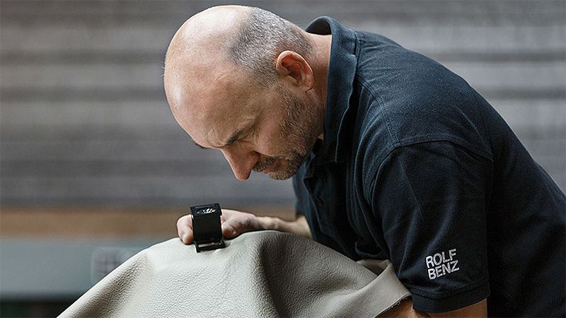 Mitarbeiter von Rolf Benz führt eine Qualitätskontrolle von Leder durch. 
